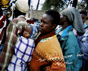 A child waiting in line with others for relief aid