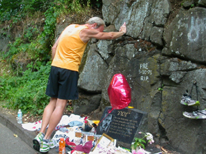 A man rests near a memorial site