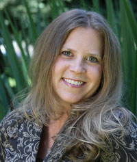 A woman in front of trees