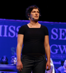 A woman speaking on stage