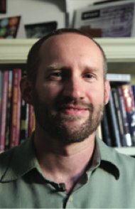 A man in front of a bookcase
