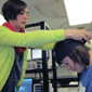 A woman placing a brain cap on a young girl