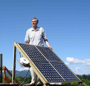 A man near a large sun panel 