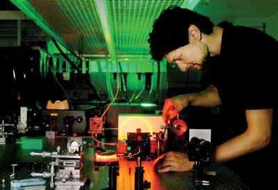 A man in a laboratory working with lasers