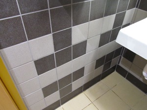 The tiled wall of a restroom