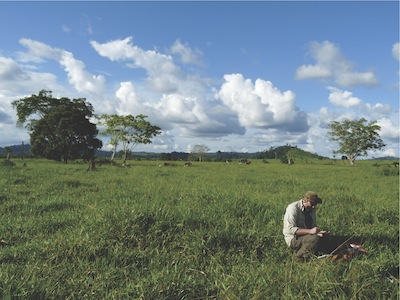 A man surveying in a field