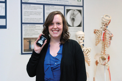 A young woman with an iPod touch in a laboratory