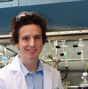 Young man wearing white lab coat in science laboratory