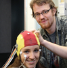 Young man placing brain cap on young woman