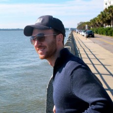 Shane Lofgren stands by the water