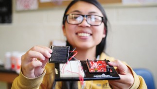 student building a solar-charging phone case